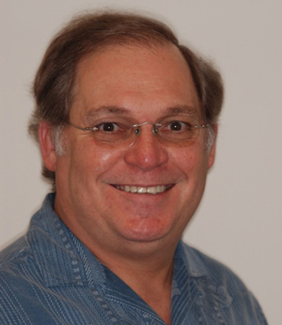 Man with glasses smiling, a patient at Karl Hoffman Dentistry in Lacey, WA