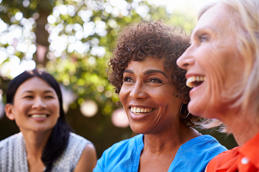 A group of smiling older women with dental implants from Karl Hoffman Dentistry in Lacey, WA