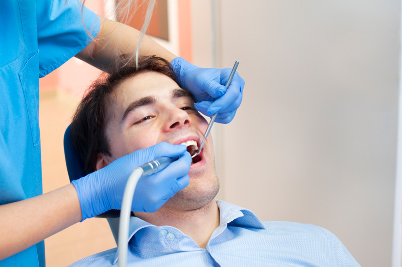 Man receiving dental cleaning from dental hygienist at Karl Hoffman Dentistry in Lacey, WA